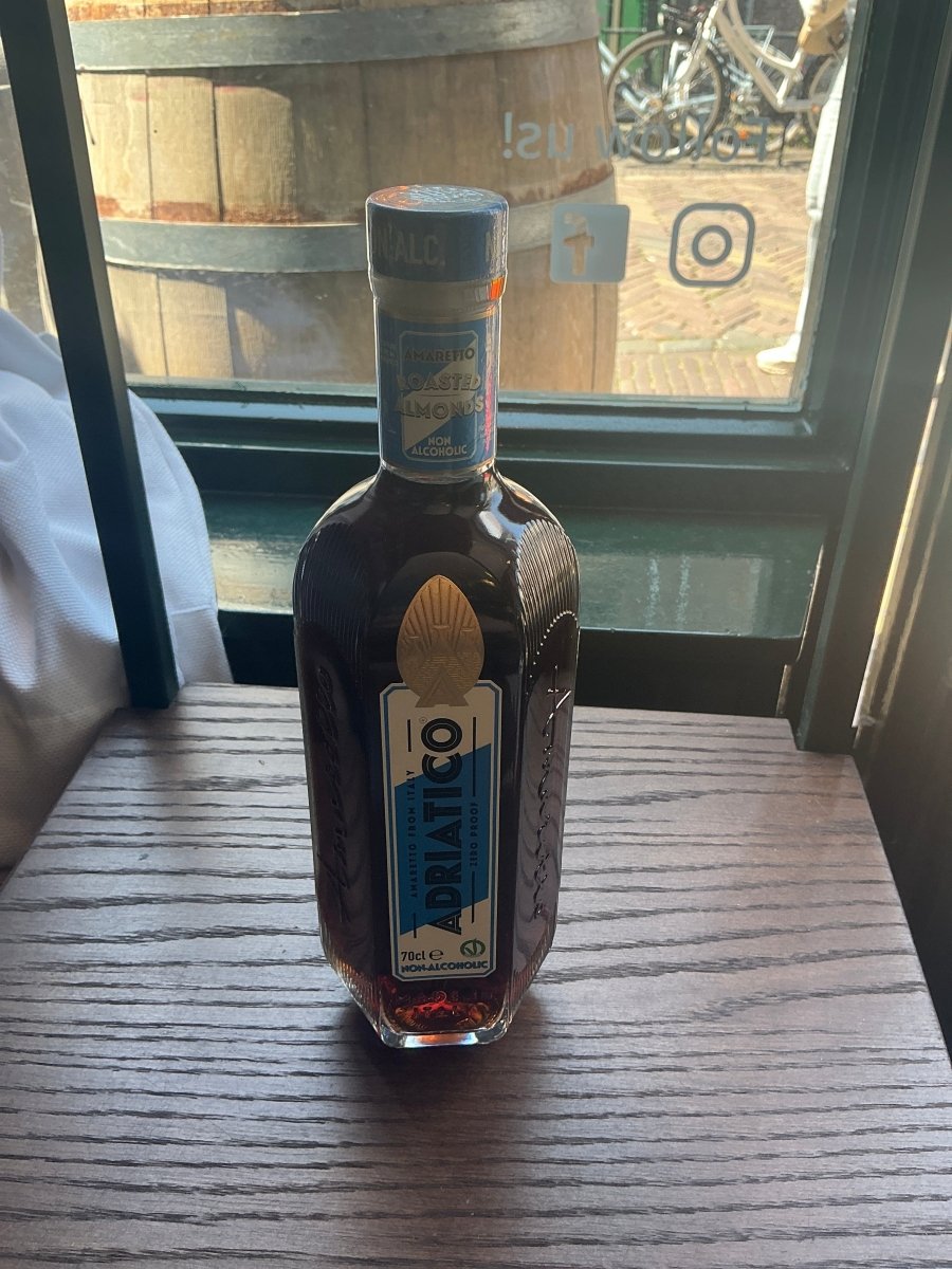 Adriatico Non-Alcoholic Amaretto 700ml bottle with blue and gold label, Italian non-alcoholic amaretto liqueur alternative, 0% vol