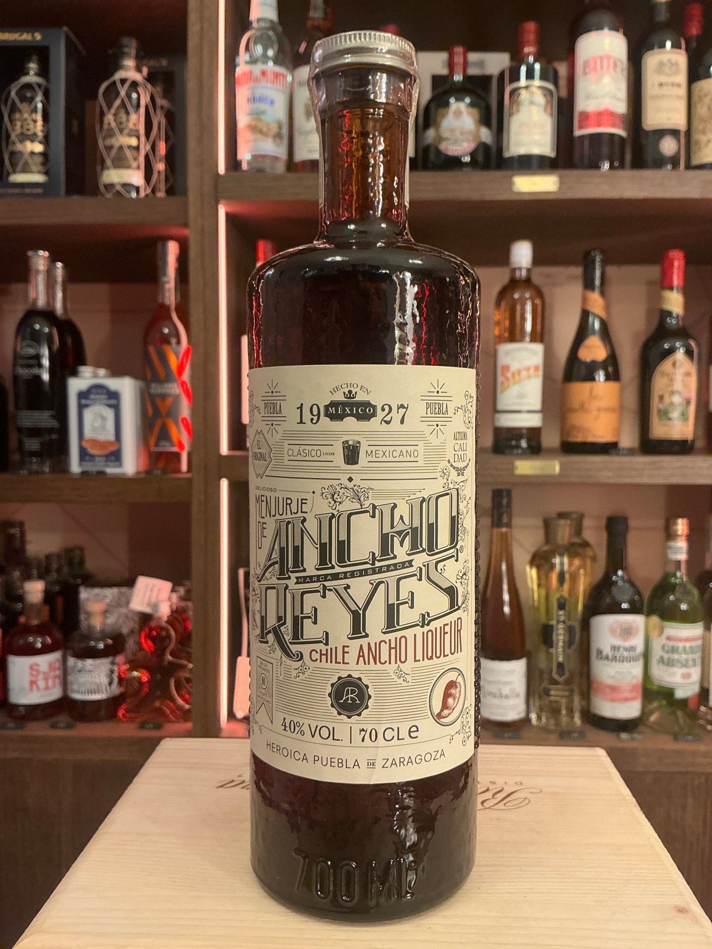 Ancho Reyes Chilli Ancho Liqueur bottle with spiced botanical label, premium artisan design, small batch specialty spirit.