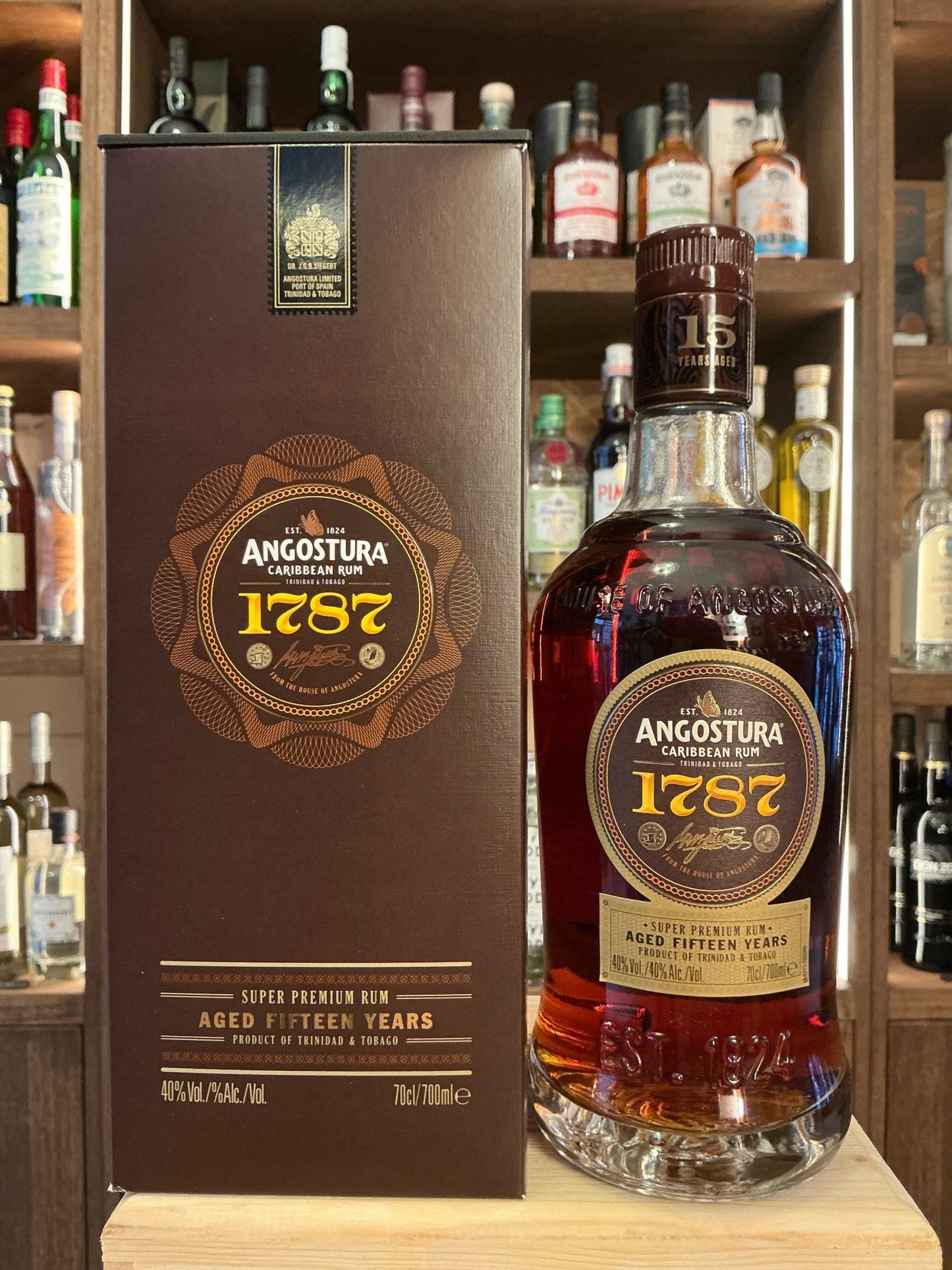 Angostura 1787 premium aged rum bottle alongside matching dark brown box, 15 years distilled artisan spirit with spiced.