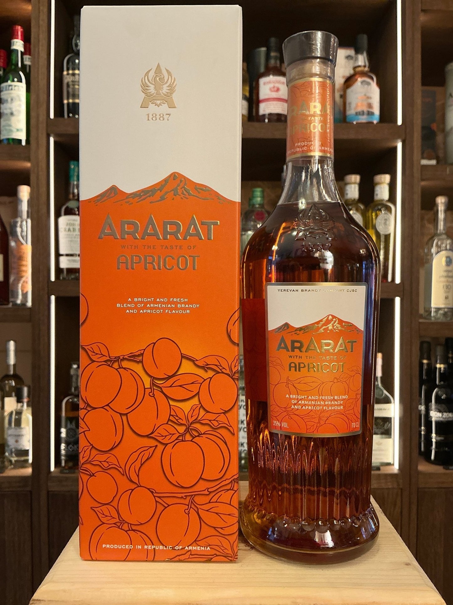 Ararat Apricot bottle of premium Armenian brandy with orange label and matching box featuring apricot illustrations, aged.