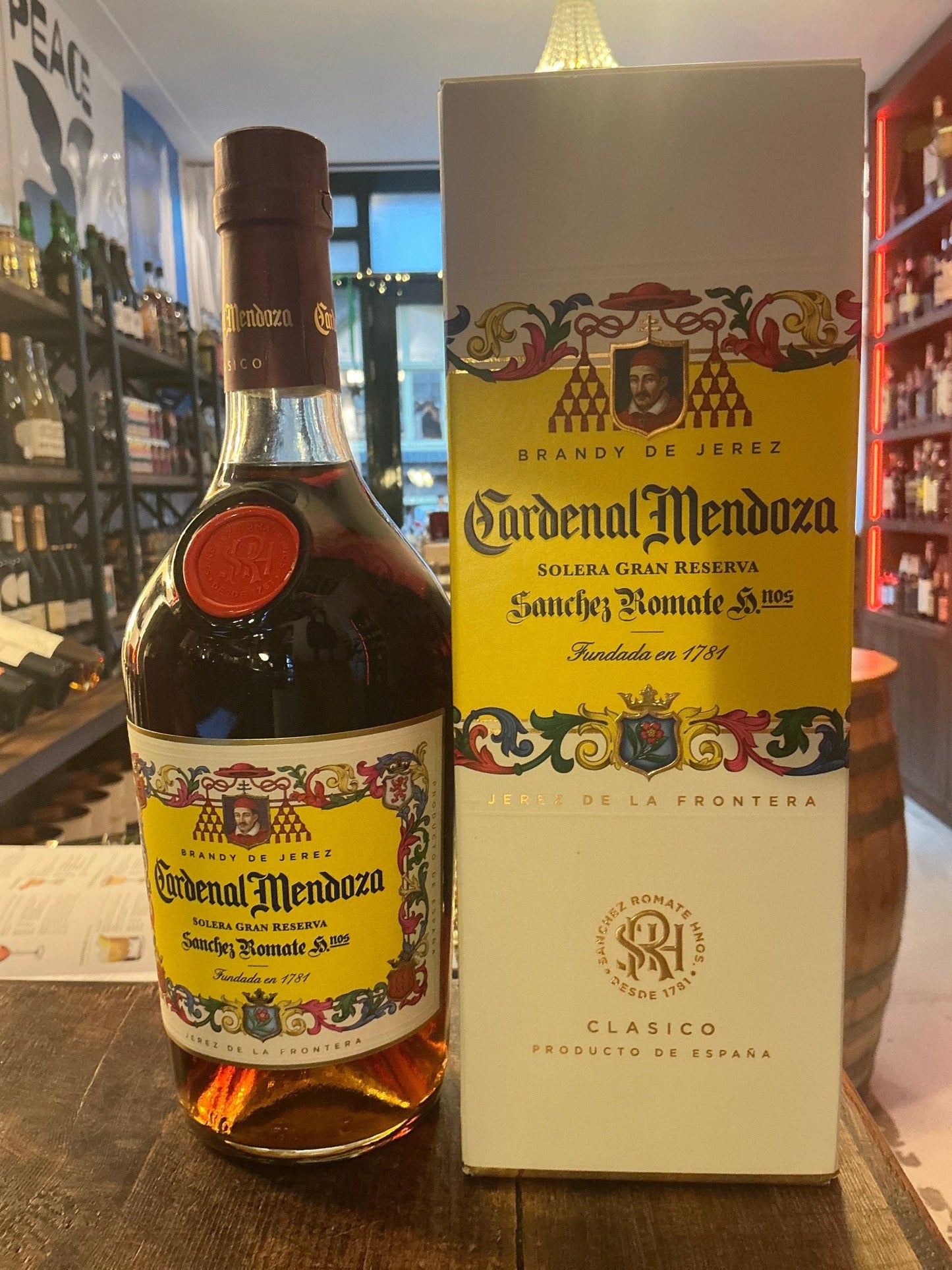 Cardinal Mendoza Solera Gran Reserva brandy bottle with yellow label and brown cap beside matching premium box, aged.