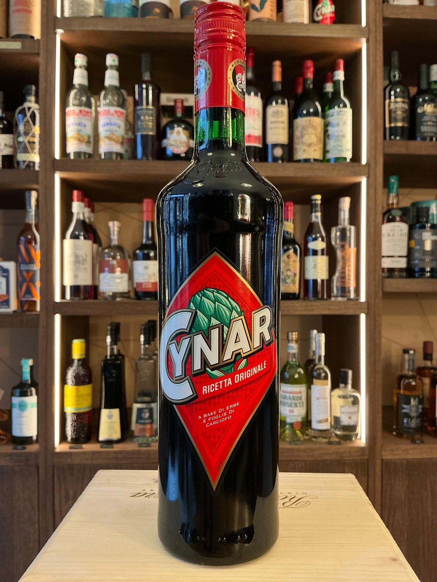 Cynar premium Italian herbal liqueur bottle with red cap and green neck label, botanical and spiced flavor in small batch.