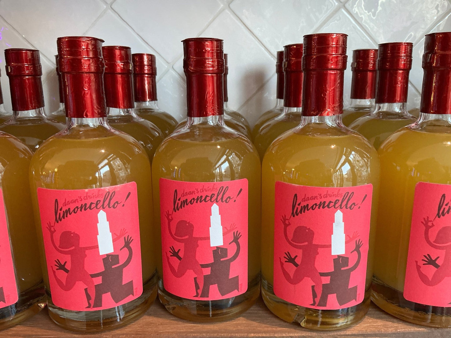 Daan's Drinks Limoncello 0.5L small batch artisan Dutch liqueur in clear bottles with red caps and vibrant pink labels.