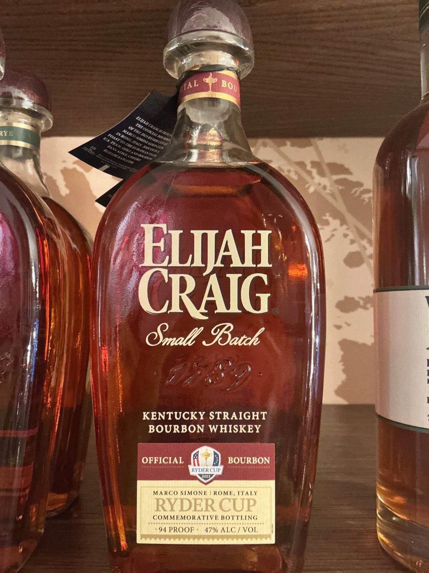 Elijah Craig Small Batch Kentucky Straight Bourbon Whiskey bottle with amber liquid, aged and distilled premium artisan.
