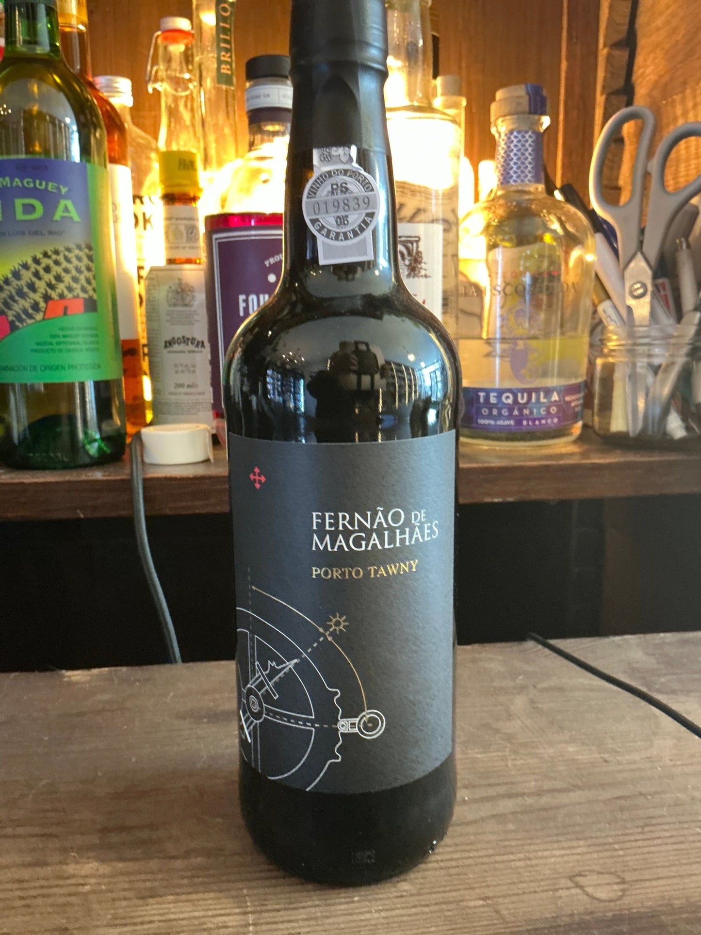 Fernão de Magalhães Port Tawny bottle with dark label featuring nautical design, premium aged fortified wine among artisan.