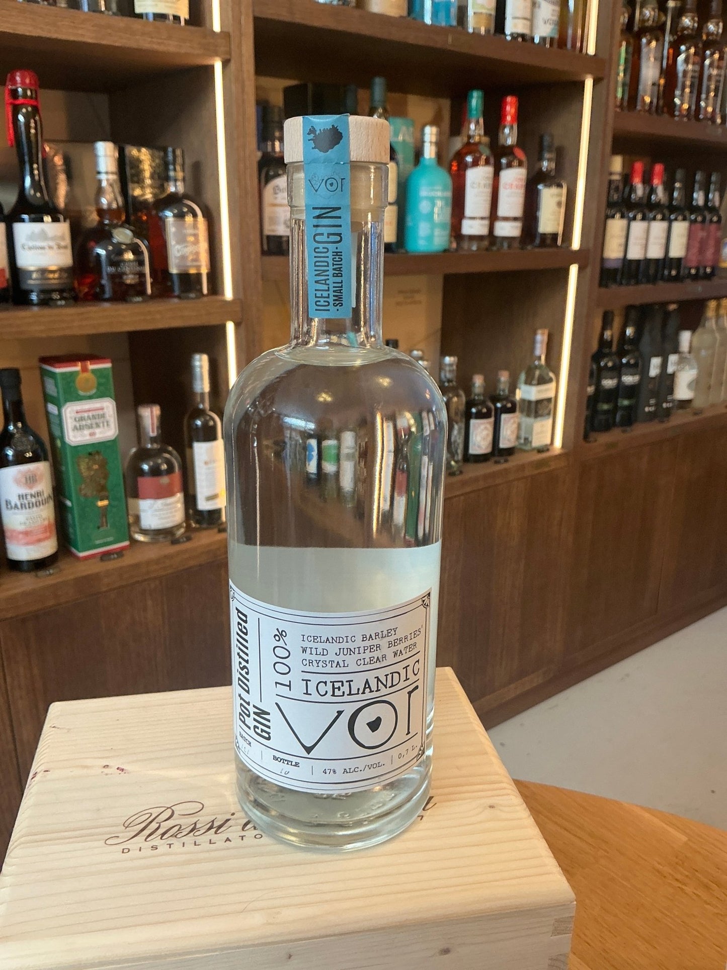 Clear glass bottle of For Icelandic Gin with minimalist white and blue label, featuring premium craft Dutch artisanal.