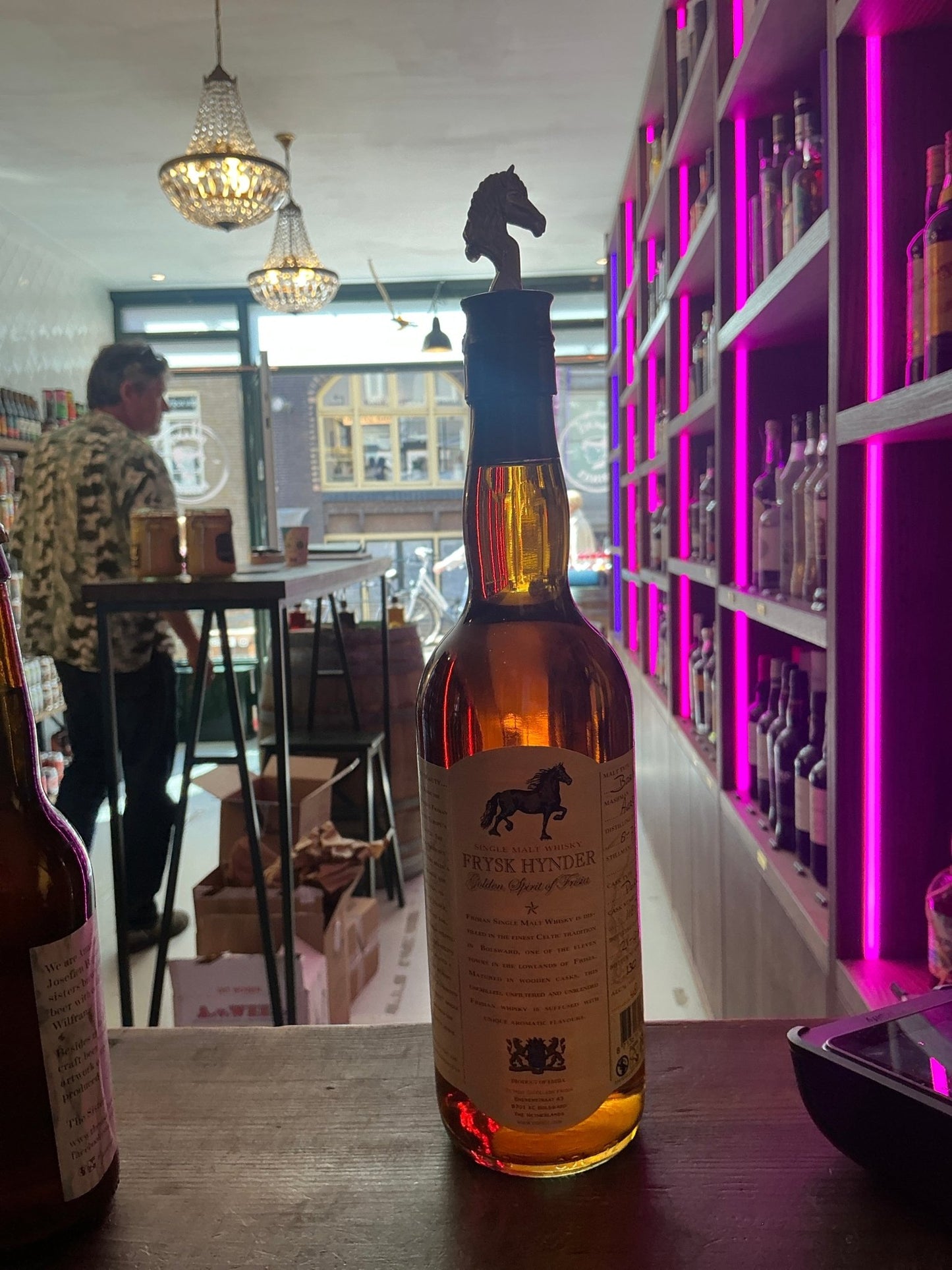 Frysk Hynder Gold Dutch single malt whisky bottle with black horse head stopper, amber liquid, premium artisan small-batch.