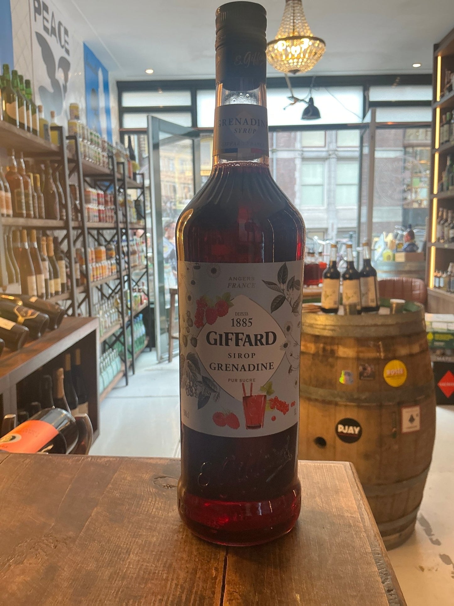 Giffard Grenadine Syrup bottle with rich red hue, artisanal label featuring botanical illustrations, premium small batch.
