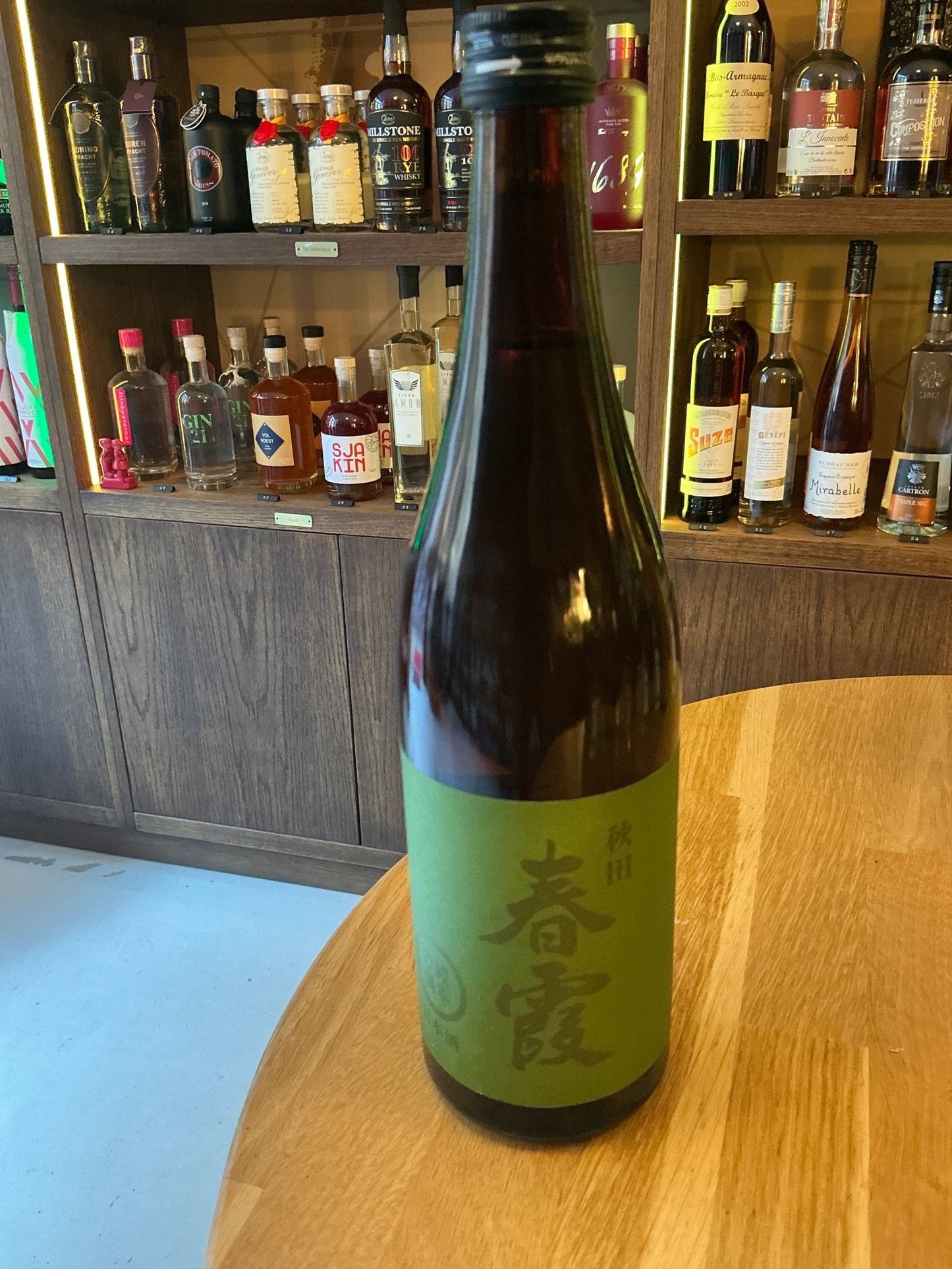 Harukasumi Junmai Ginjo Green sake bottle with light green label featuring Japanese calligraphy, premium craft artisanal.
