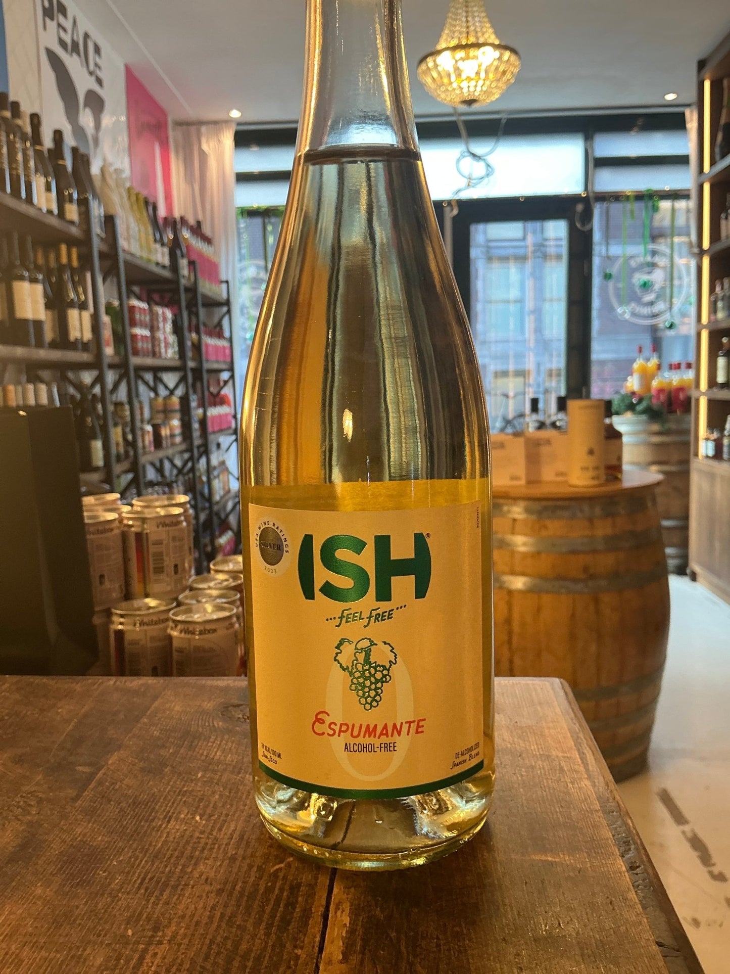 ISH Espumante alcohol-free sparkling wine bottle with green and orange label on wooden table, artisan Dutch specialty.