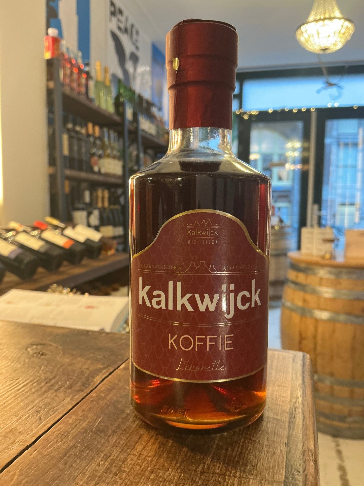 Kalkwijck Koffie liqueur bottle with deep amber liquid, red and white label, artisanal Dutch small-batch premium spirit.