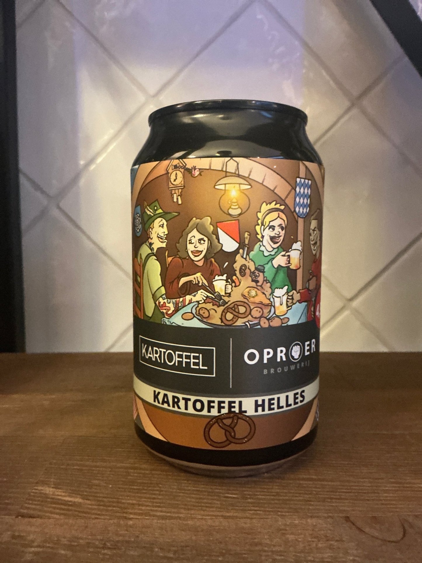 Dutch artisanal craft lager can with vintage-style label featuring festive group, labeled Kartoffel Helles premium limited.