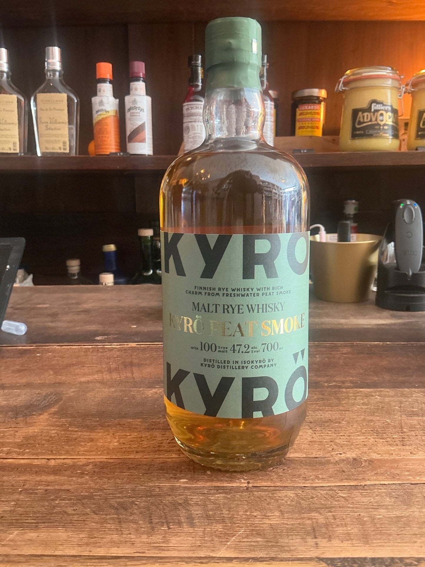 Kyro Peat Smoke Rye Whisky bottle with light amber liquid, green label highlighting smoky, peated rye spirit, premium.