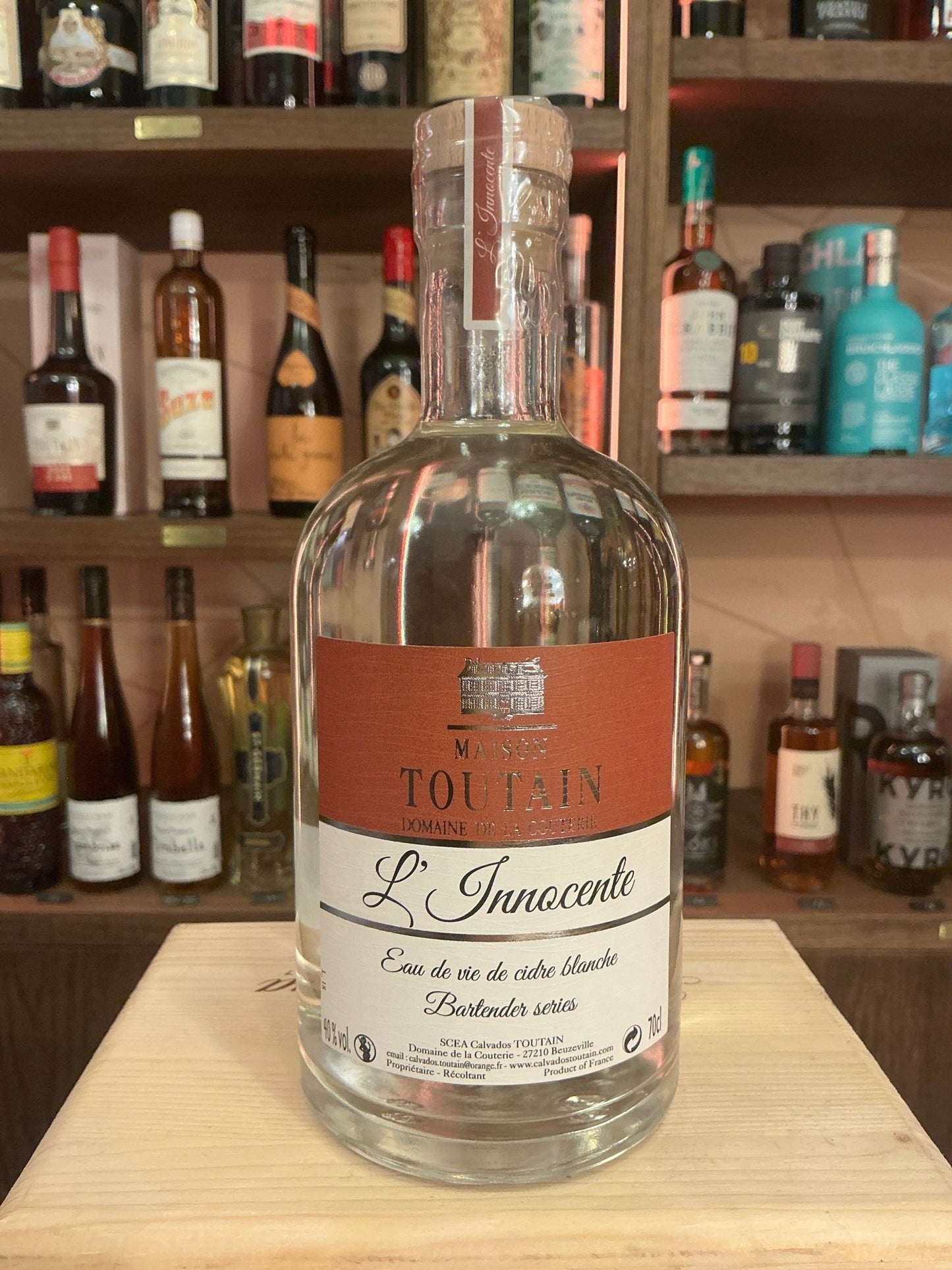 L’innocente Eaux de Vie De Cidre Blanche clear glass bottle with copper label, premium distilled artisanal brandy, small.