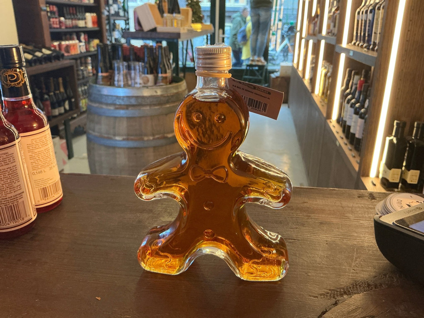 Mannetje Peperkoek spiced Dutch liqueur in gingerbread-shaped glass bottle with amber liquid, artisan small batch specialty.
