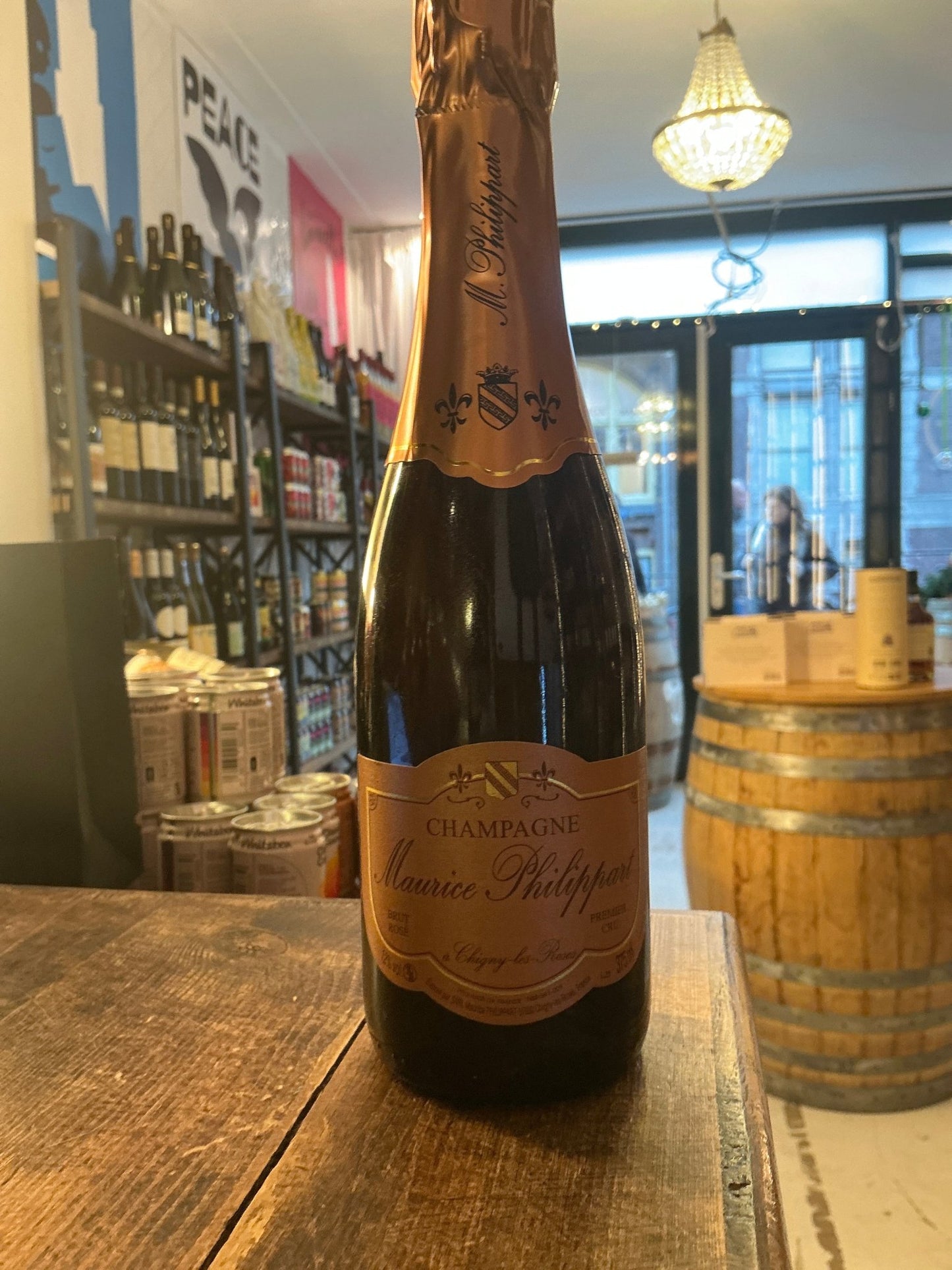 Maurice Phillart Rosé Champagne 37.5cl bottle with copper foil top and elegant label on rustic wooden table in artisan.