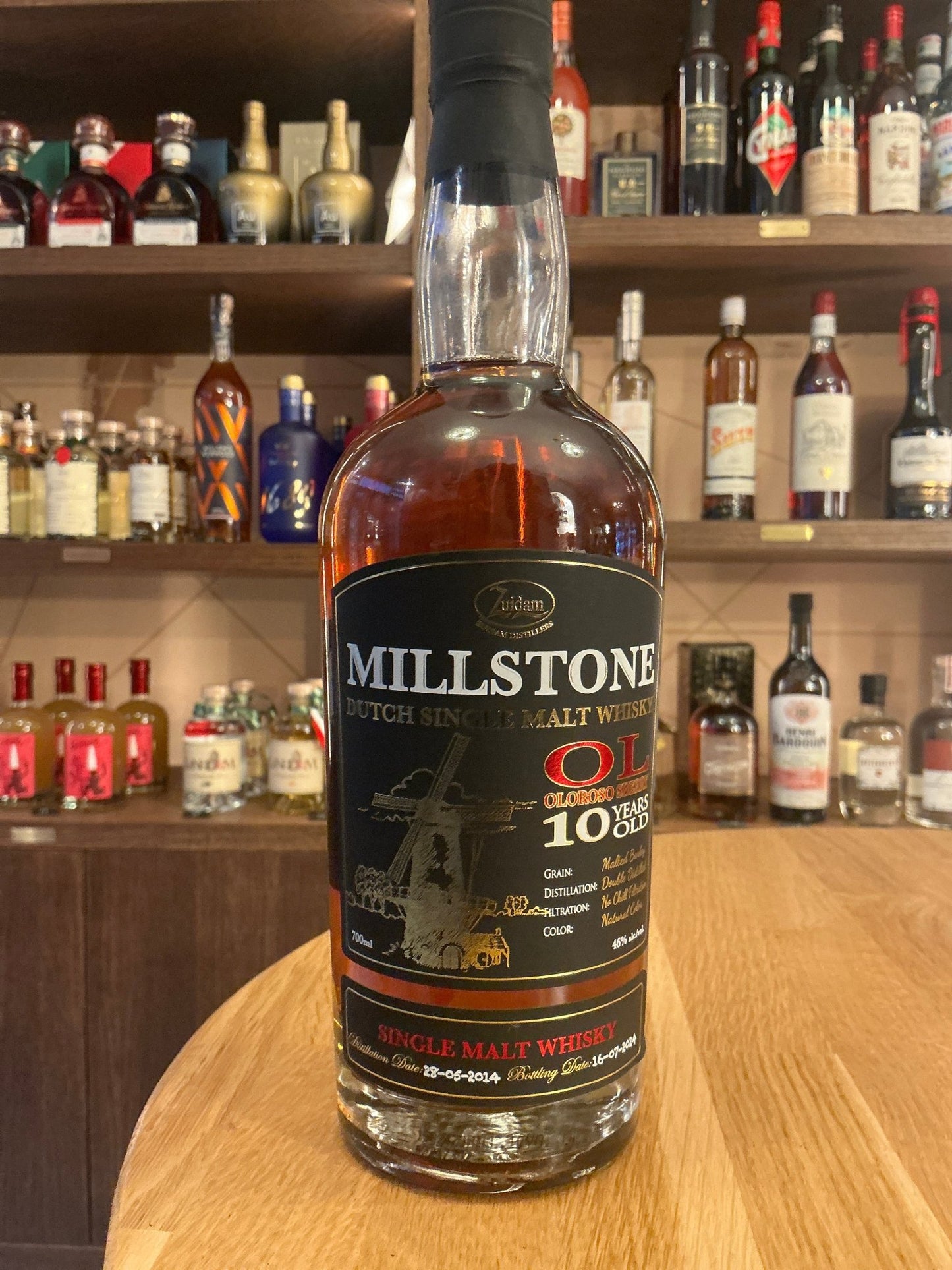 Millstone Single Malt Sherry Cask 10-Year-Old Dutch whisky bottle with premium aged, spiced and botanical flavors on wooden.