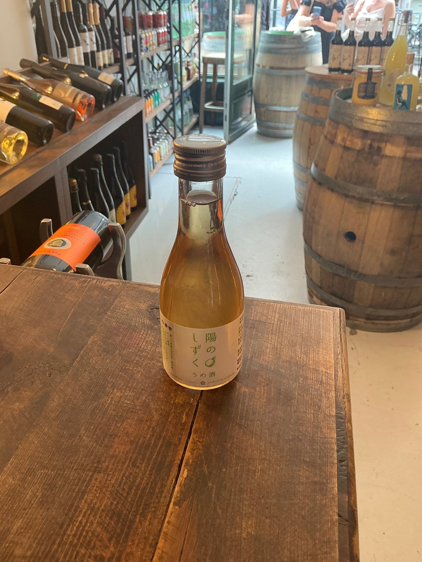 Small 180ml Miyakanbai Ume plum sake bottle with light amber liquid, artisan Japanese fruit liqueur, premium distilled.