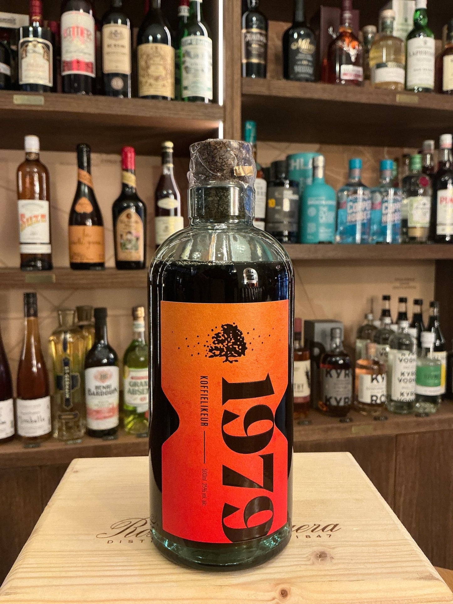 Ravenveld Koffie Likeur bottle with bold orange label, premium Dutch coffee liqueur, artisan small batch spirit.