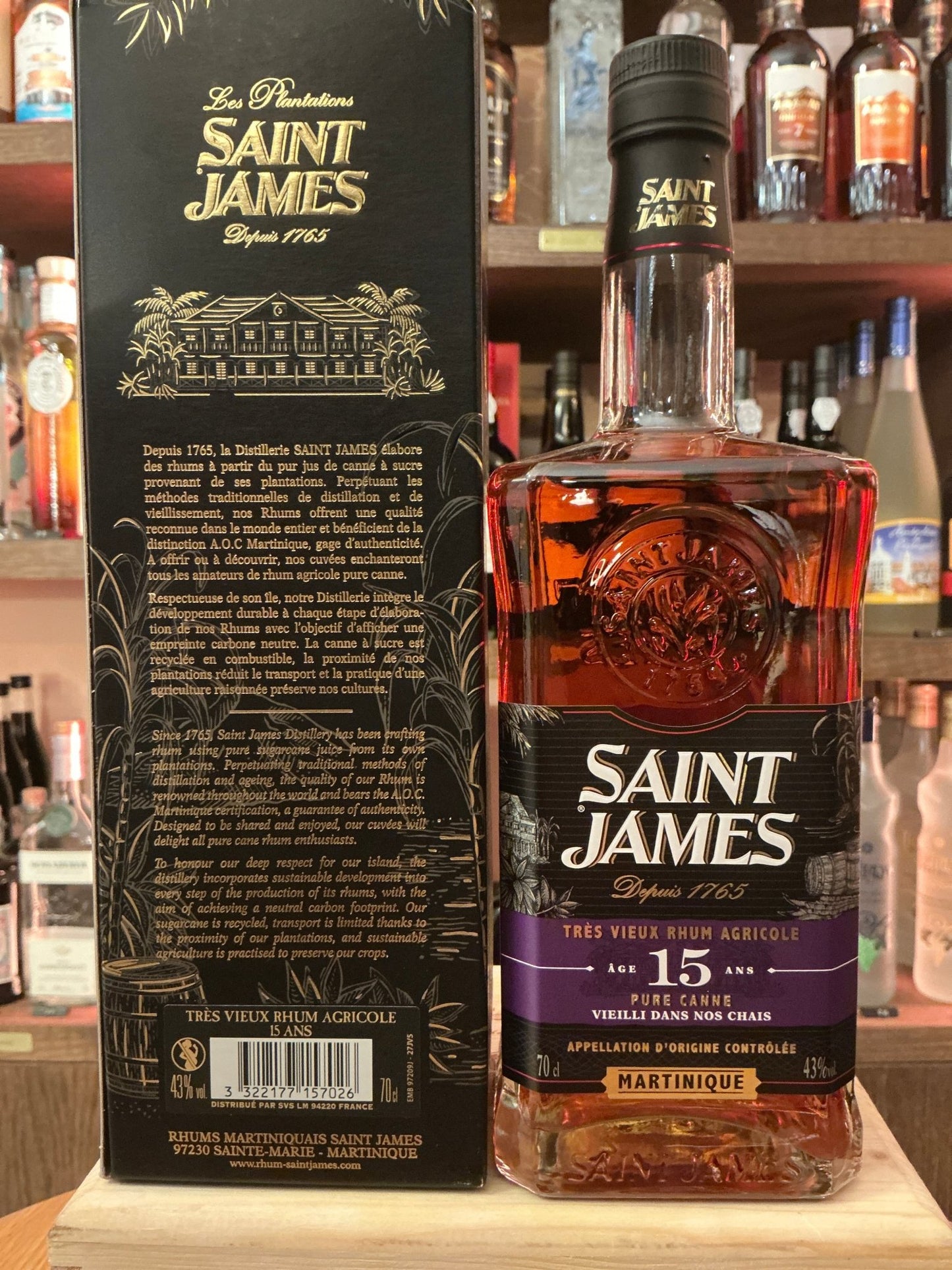 Saint James 15 Ans Rhum Agricole bottle with rich amber liquid, premium aged Martinique rum, detailed embossed glass, black.