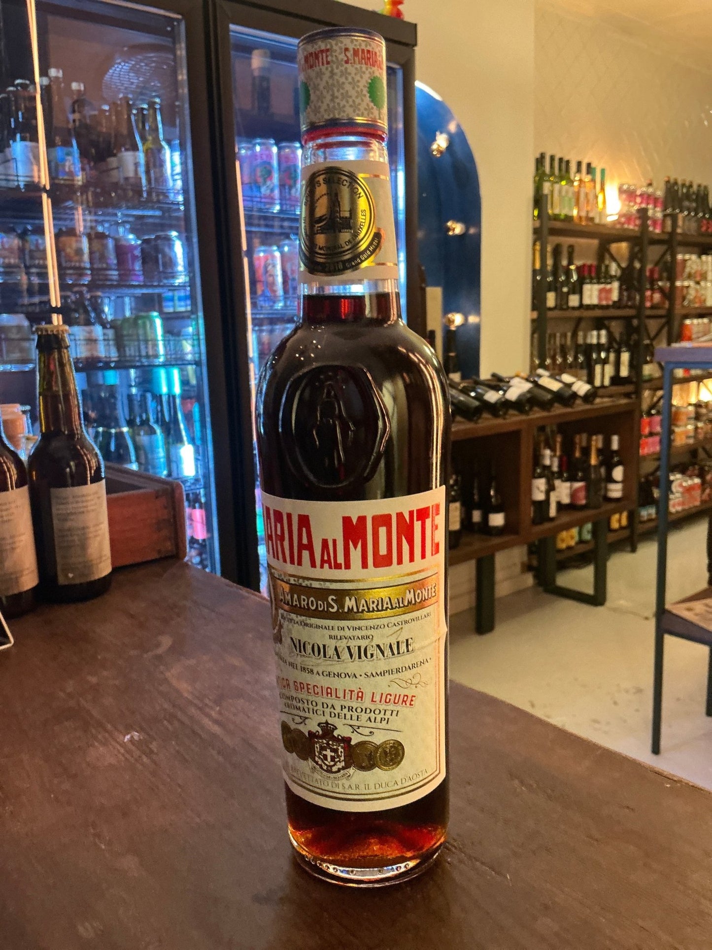 Santa Maria Amaro premium spiced herbal liqueur bottle, dark amber liquid, artisan small batch specialty spirits.