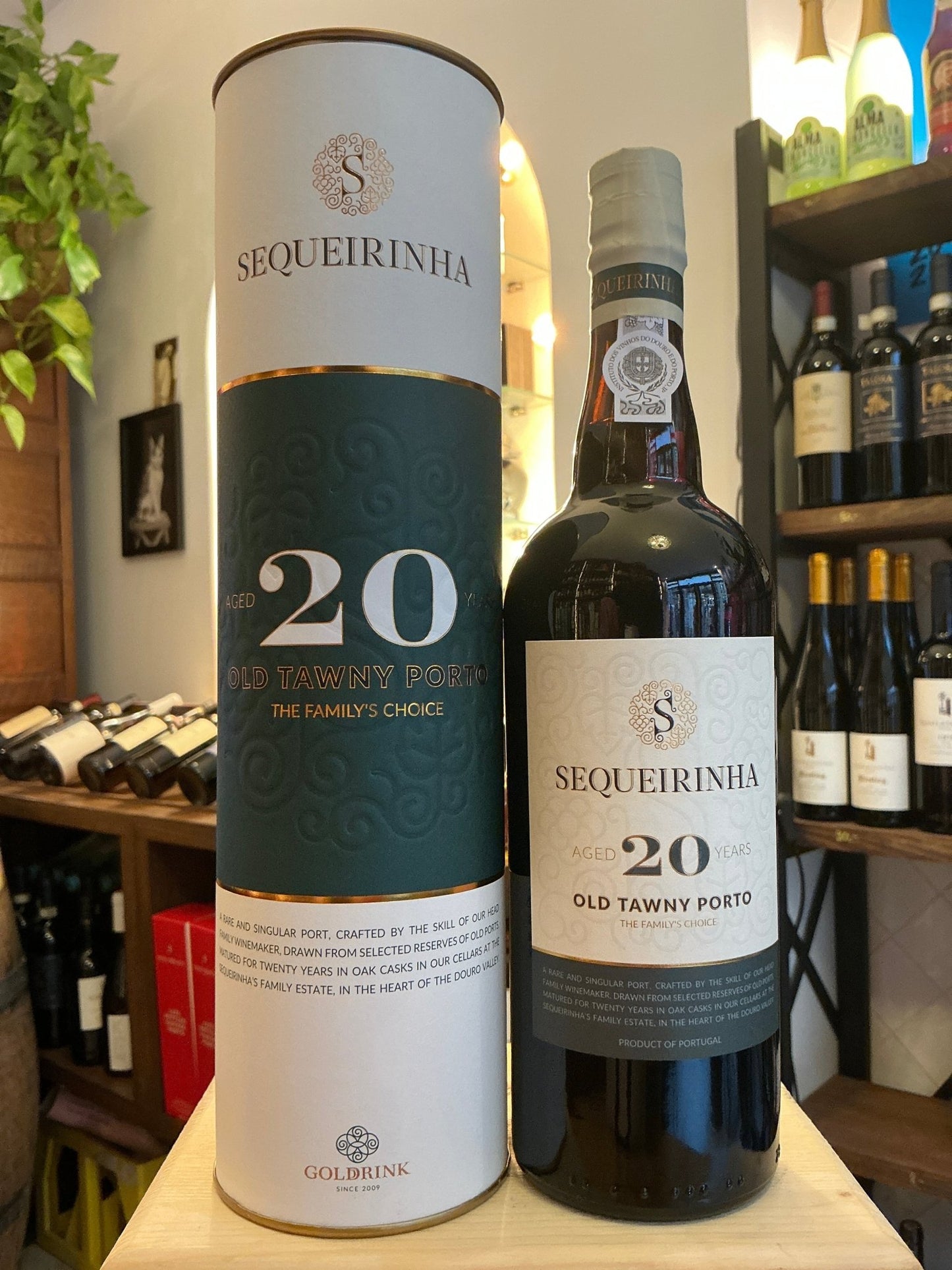 Sequeirinha 20 Yr Old Tawny Port bottle with matching white and green cylindrical box, premium aged fortified wine with.