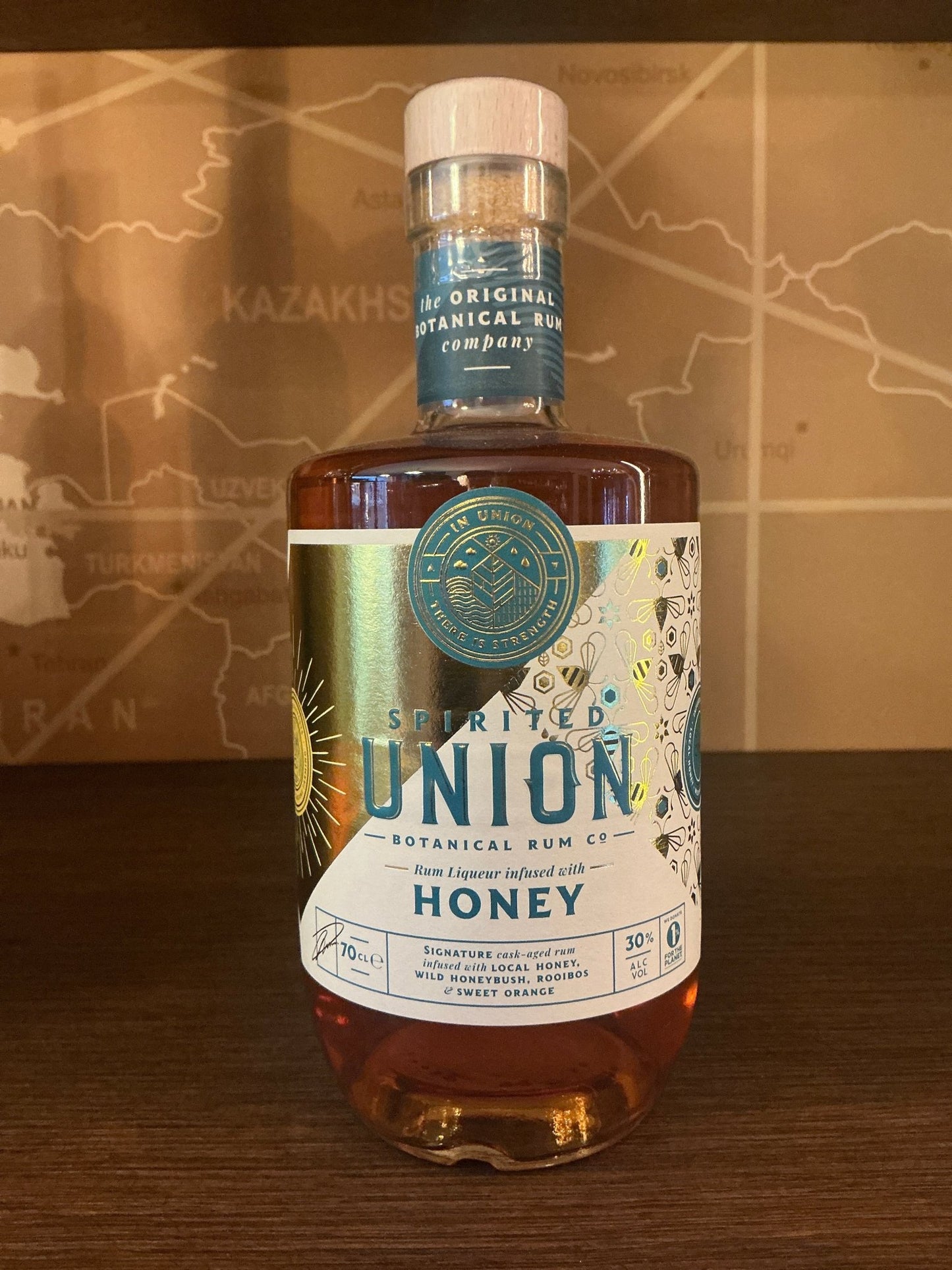 Spirited Union Honey Rum Liqueur in a craft clear glass bottle with gold and blue label, Dutch artisanal limited edition.