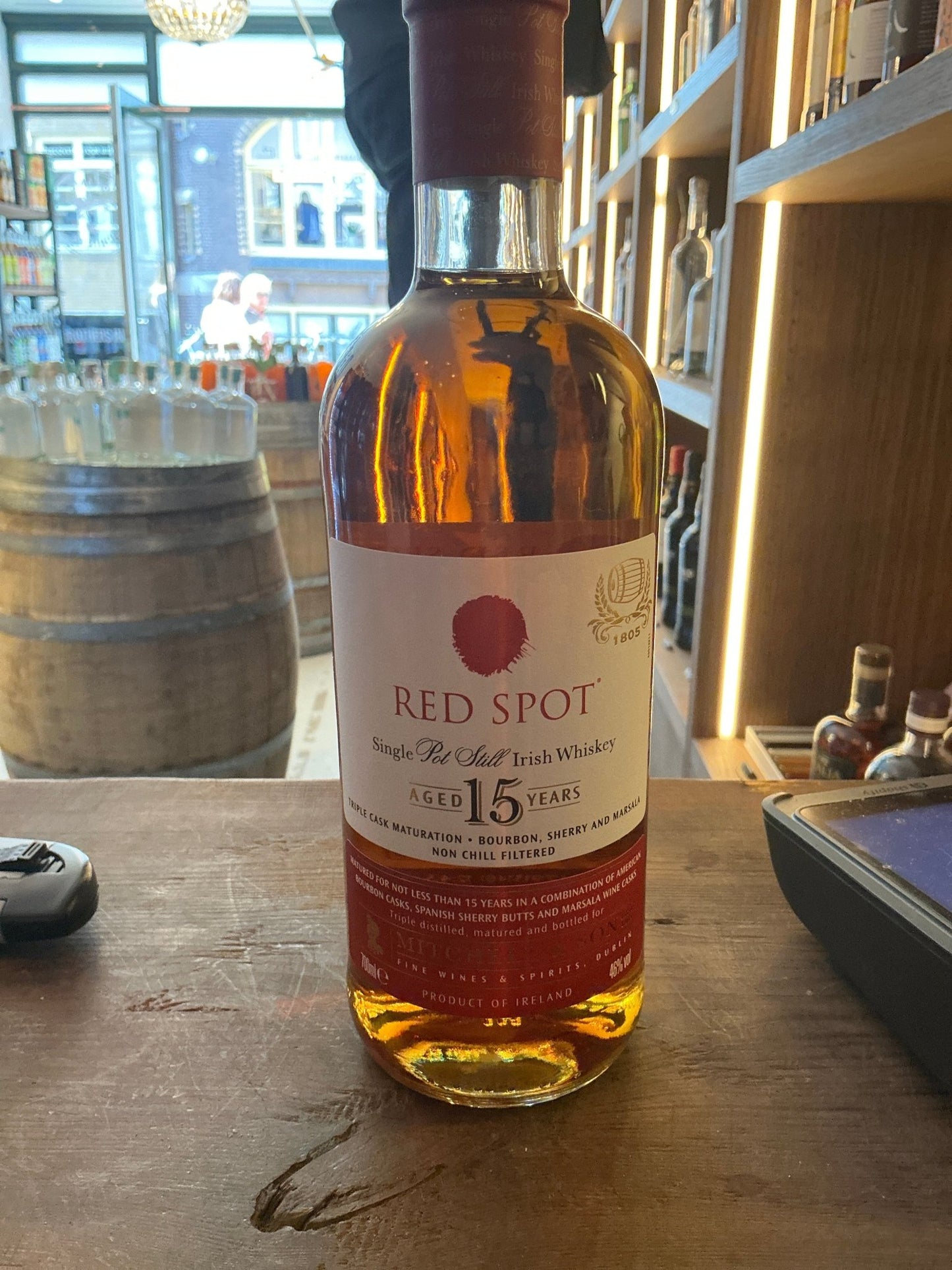 Red Spot 15-year aged Irish whiskey bottle with premium distilled amber liquid, small batch artisan spirit.