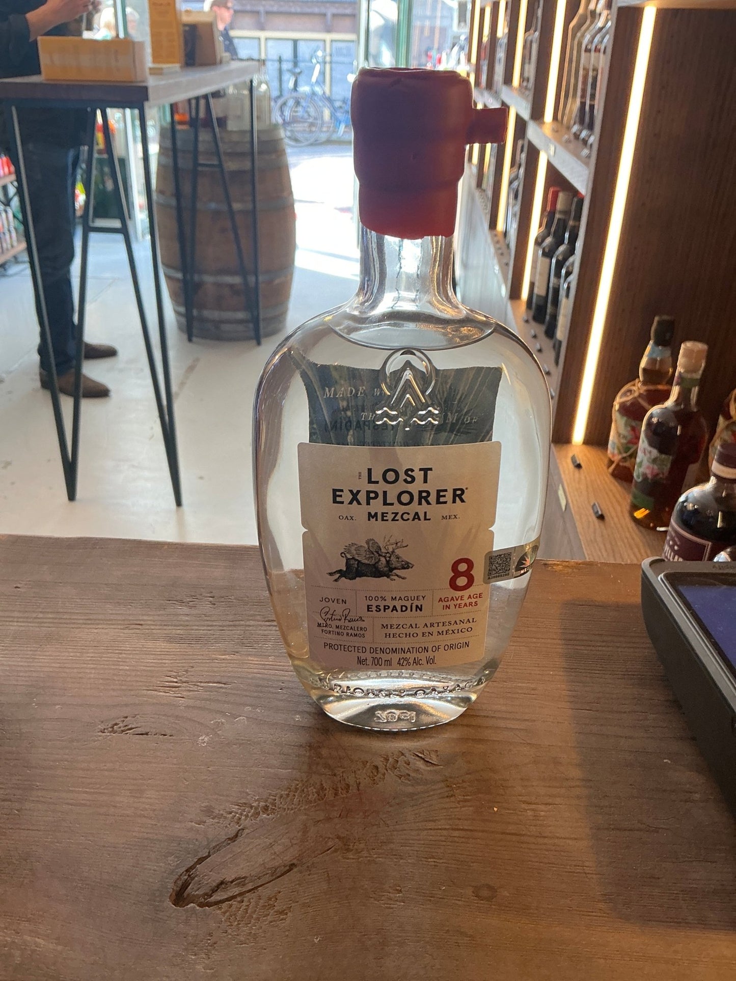 Clear glass bottle of The Lost Explorer Mezcal Espadín aged 8 years, featuring artisan Mexican mezcal with premium spiced.