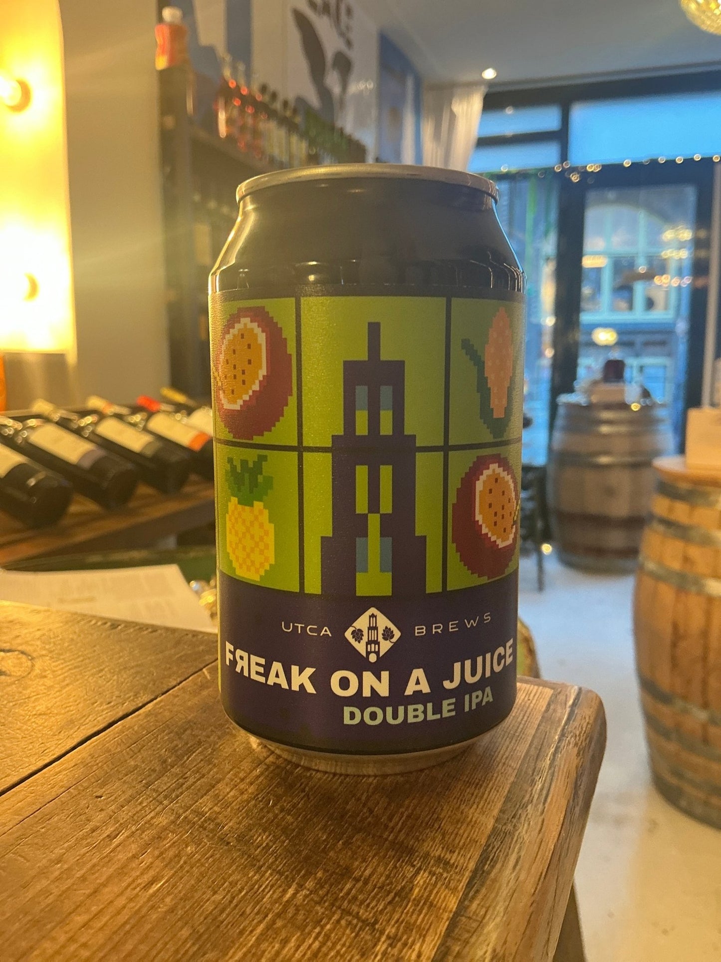 Dark blue can of UTCA Brews Freak On A Juice Double IPA craft beer with stylized pink grapefruit and green botanical.
