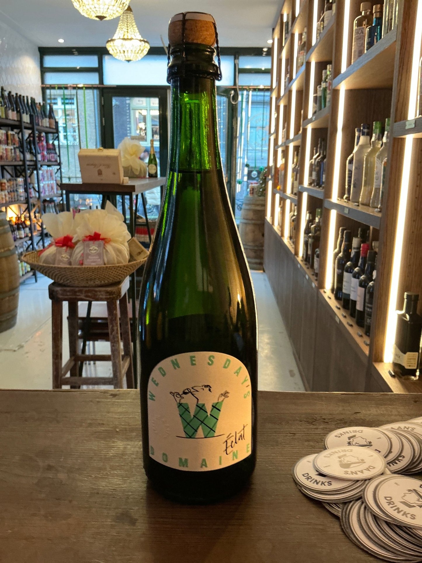 Wednesday’s Eclat sparkling non-alcoholic wine in green glass bottle with botanical-inspired label, artisan premium.