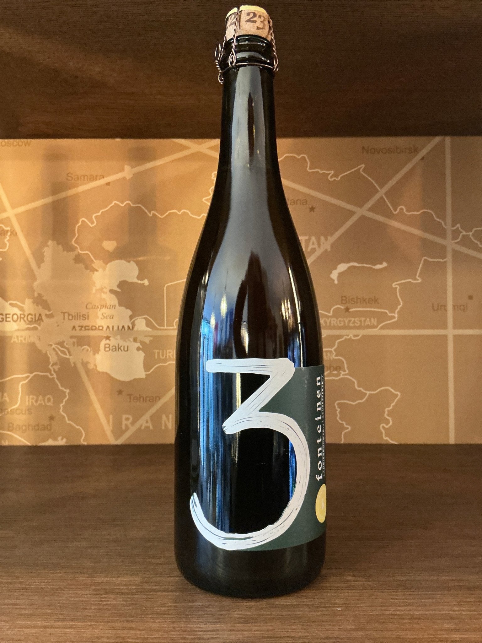 Black 750ml bottle of 3 Fonteinen Kweepeer S22/23 Dutch artisanal Lambic with minimalist white "3" label, premium limited.