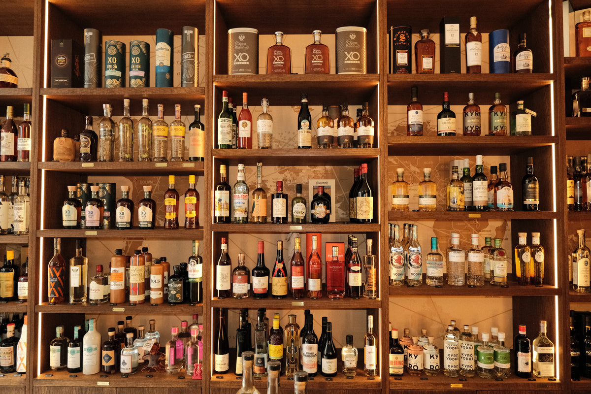 Floor-to-ceiling wooden shelves of whisky, rum, gin, cognac and liqueurs at Daan's Drinks, Vismarkt 2, Utrecht