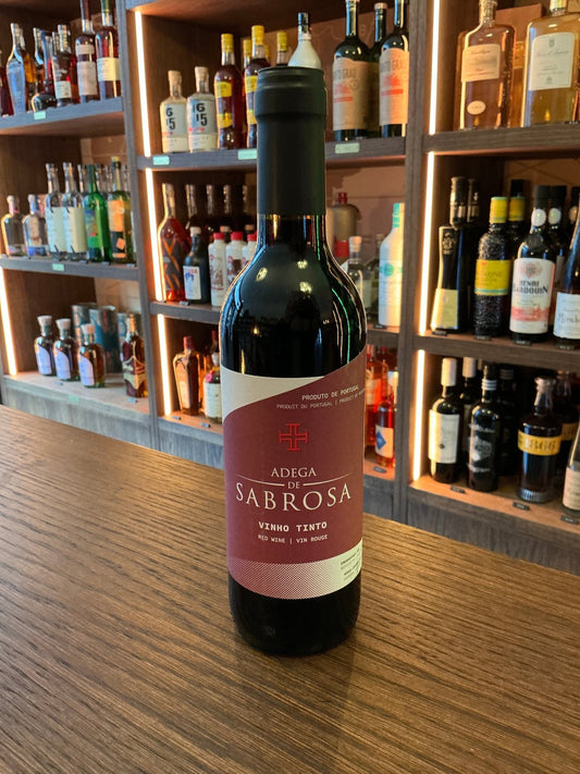 Adega de Sabrosa Portuguese red wine 37.5cl bottle with dark glass and red label on wooden bar, surrounded by premium.
