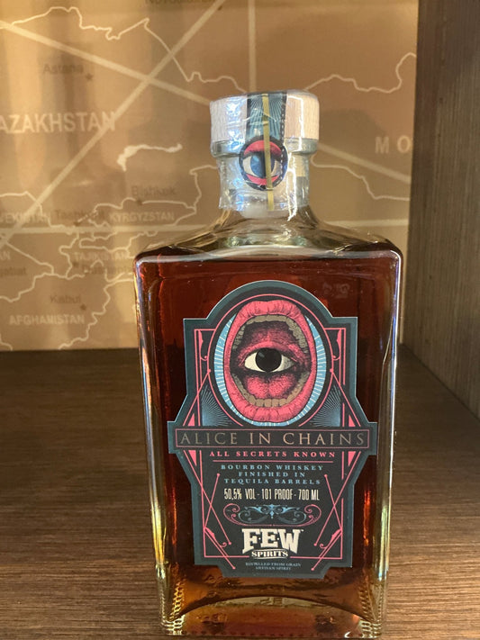 FEW ‘Alice in Chains’ Bourbon in a square glass bottle with dark amber liquid, label featuring a red eye graphic and.
