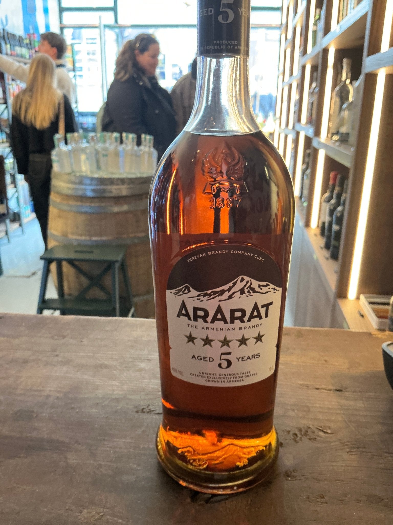Ararat Five Star 5 Year Old Armenian brandy in clear glass bottle with amber liquid on wooden surface, premium aged.