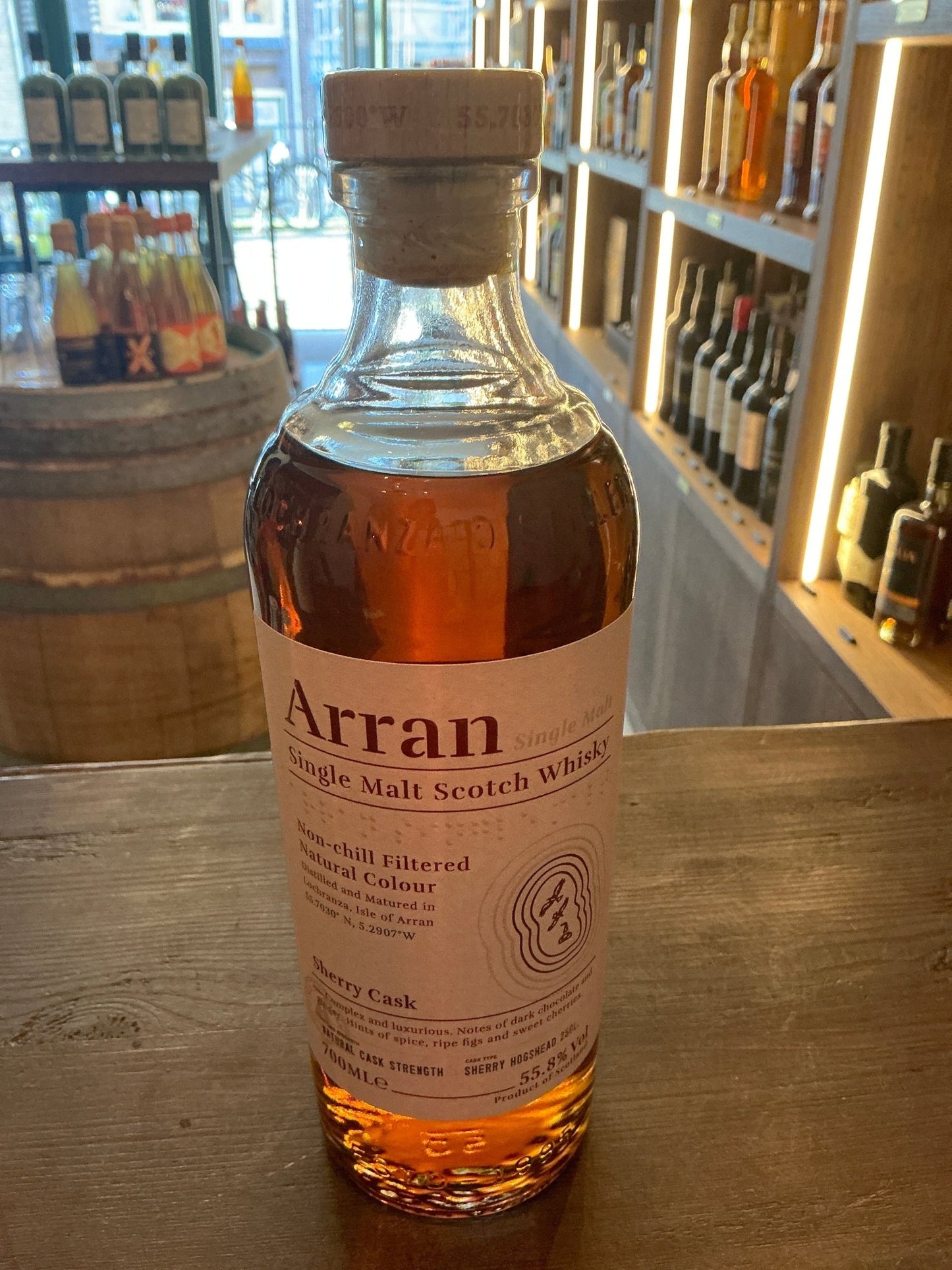 Arran Sherry Cask "The Bodega" small batch premium single malt whisky bottle with aged amber liquid and wooden cap on rustic .