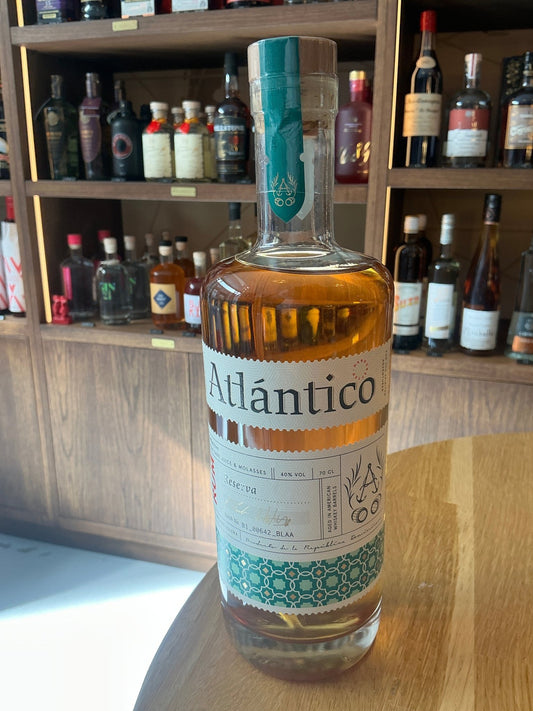 Atlantico Reserva premium aged Dominican rum bottle with artisanal Dutch design and limited edition label on wooden table.
