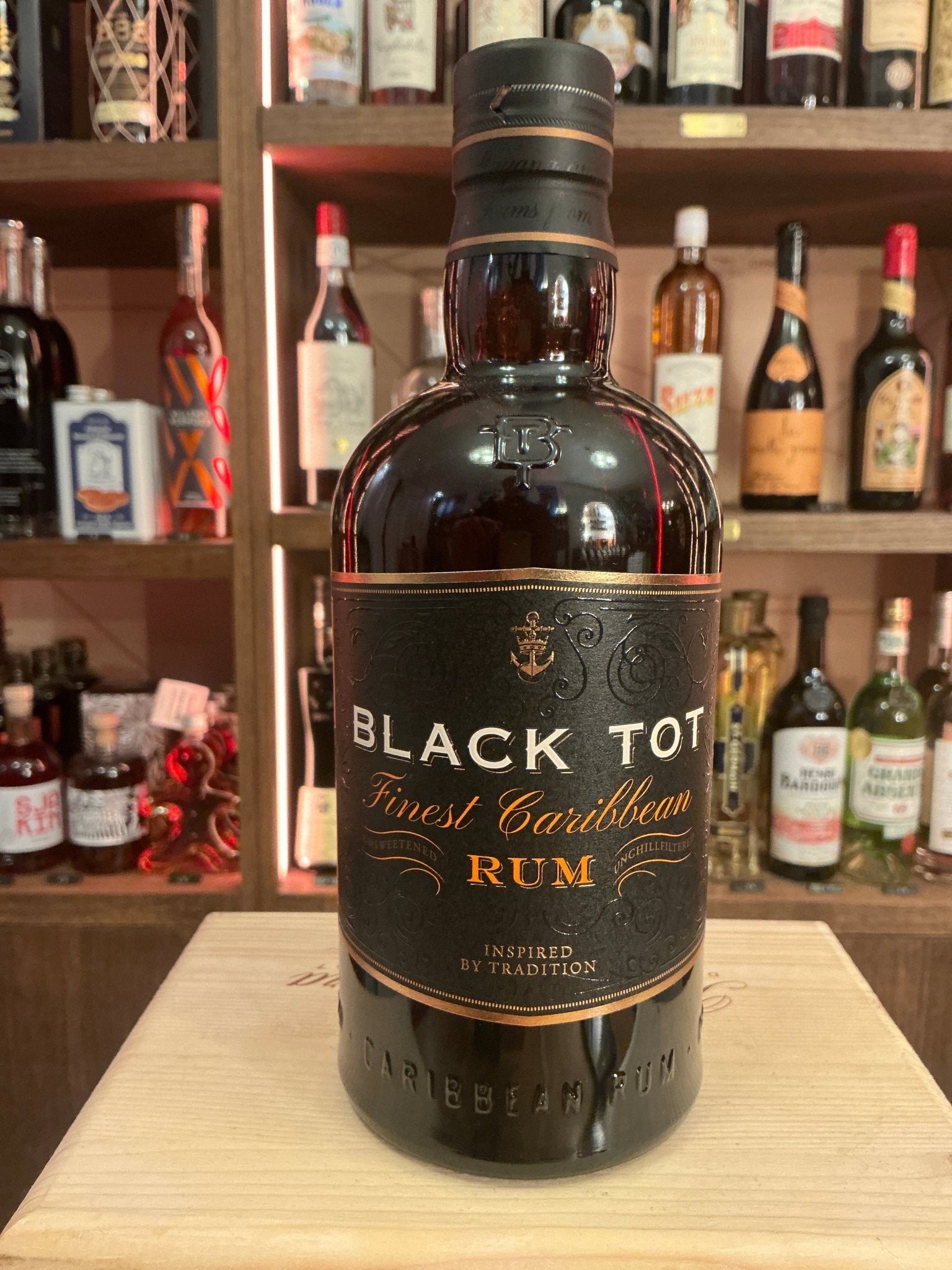 Black Tot Finest Caribbean Rum dark glass bottle with black and gold label, artisan small batch premium spiced rum.