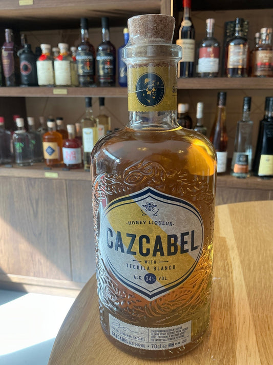 Cazcabel Tequila Honey Liqueur bottle with amber liquid, artisanal embossed glass, cork stopper, premium craft spirit ideal.
