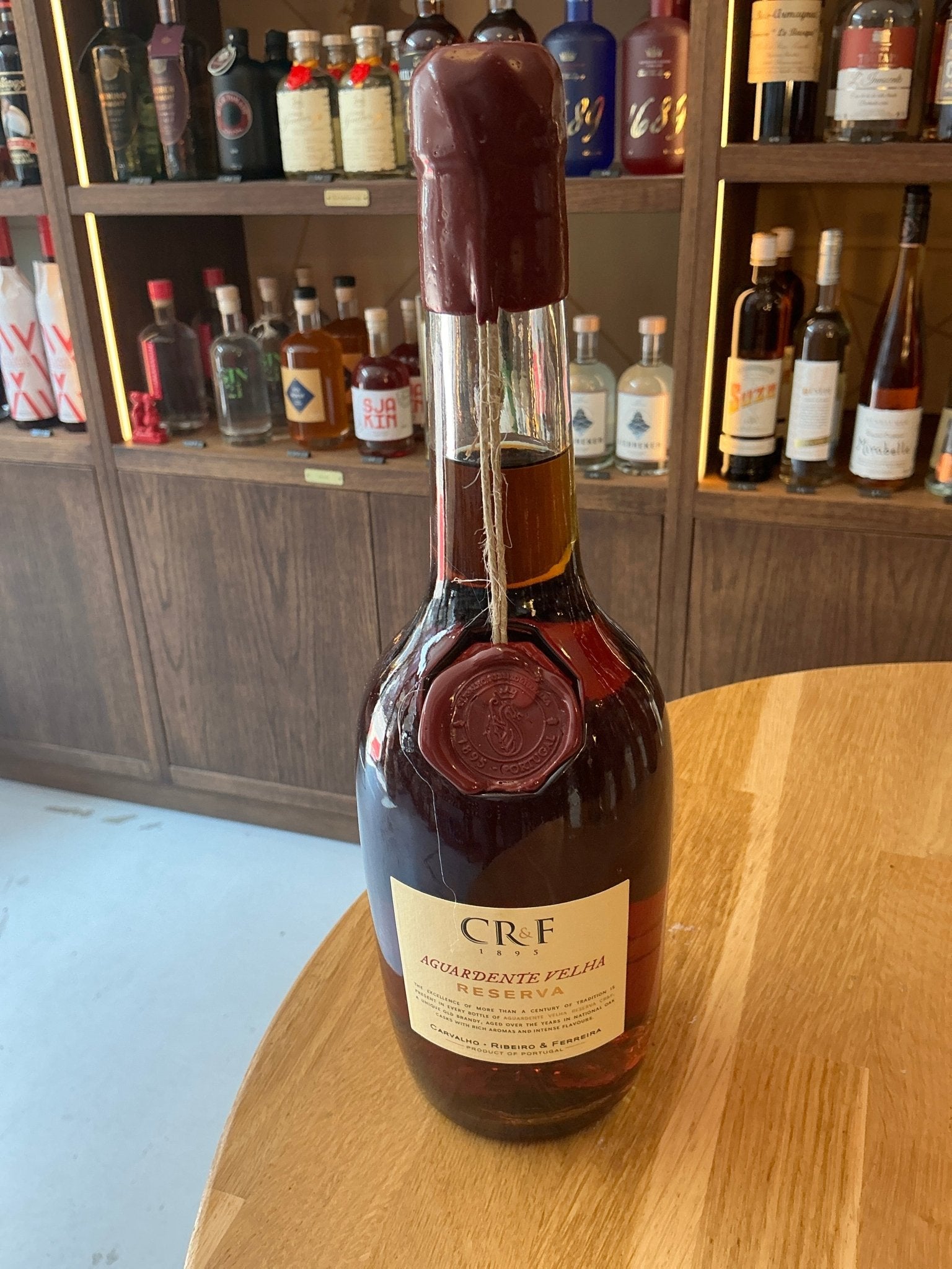 CR&F Aguardente Velha Reserva Portuguese aged brandy bottle with dark amber liquid, artisanal wax seal, and cream label.