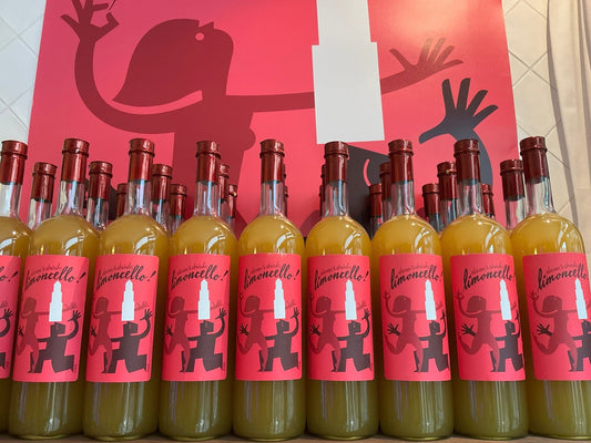 Daan's Drinks Limoncello 1L bottles with bright red labels and artisan Dutch botanical liqueur in clear glass.