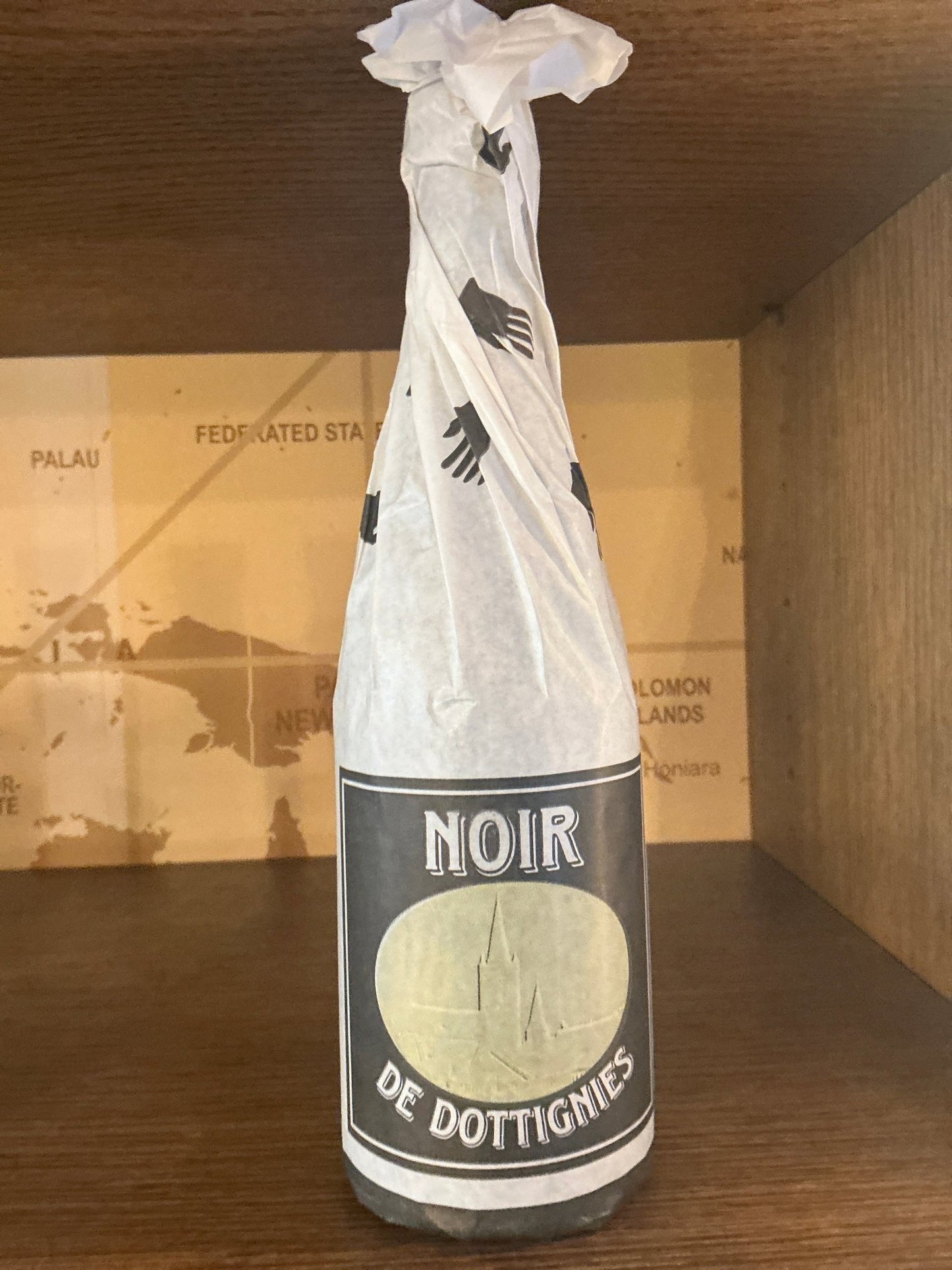 Premium craft Belgian strong dark ale De Ranke Noir Dottignies in artisanal gift-style bottle with white paper wrap and.