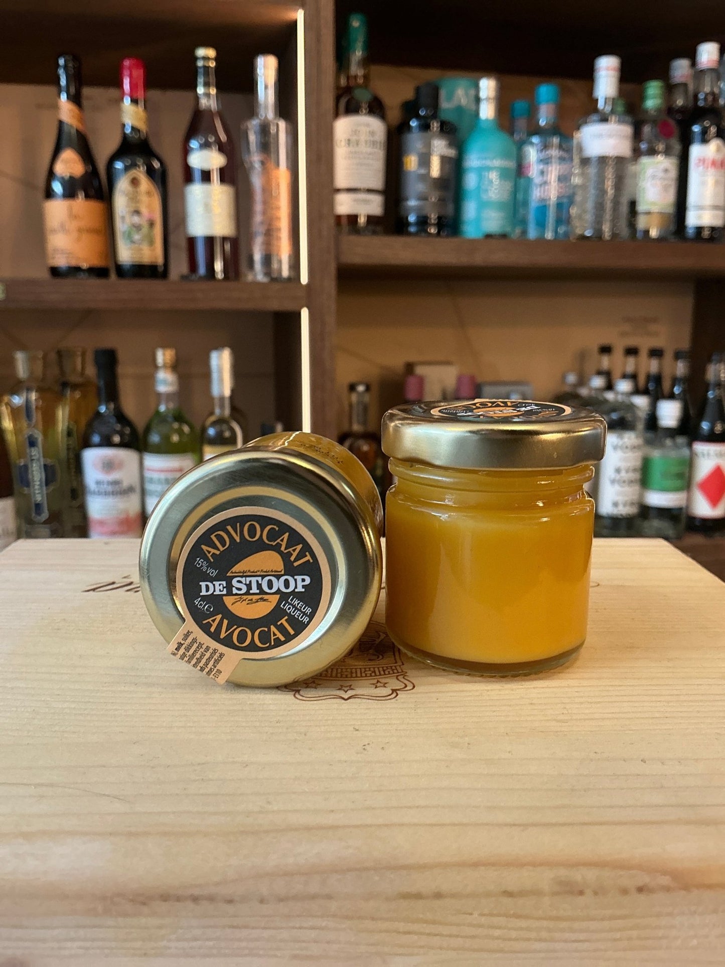 Small batch De Stoop Advocaat miniature jar with vibrant yellow spiced egg liqueur, artisan Dutch specialty spirit.