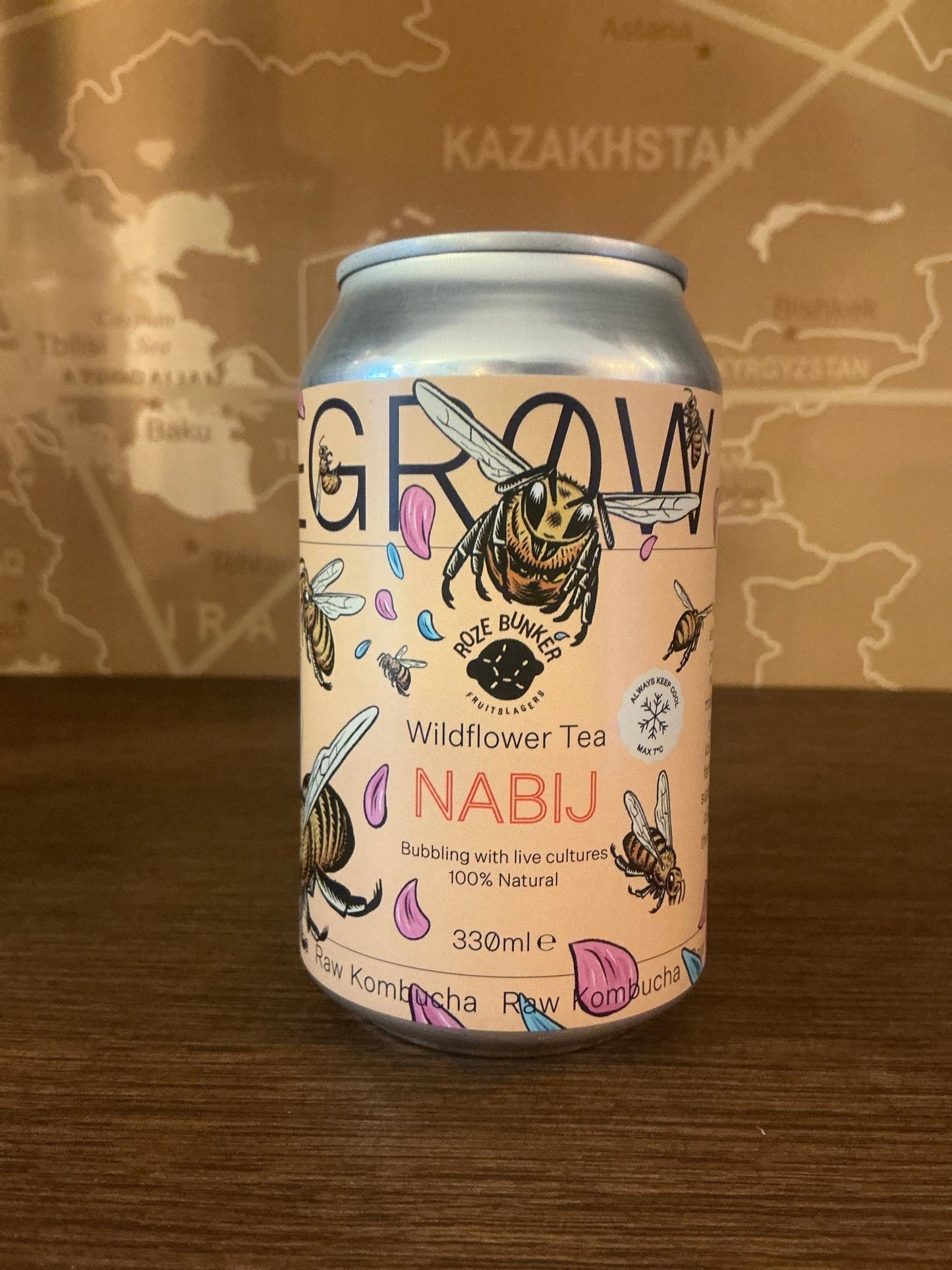 Tall silver craft can with pastel pink label featuring hand-drawn wildflowers, bees, and leaves, labeled "Degrow Lab Nabij.