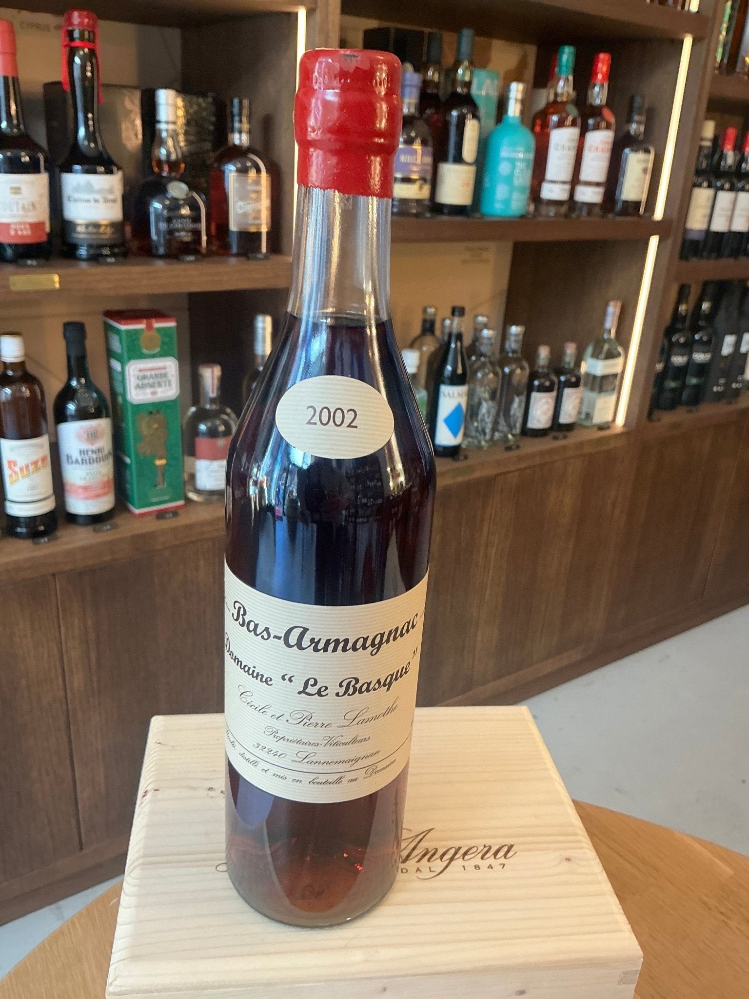 Premium Domaine le Basque 2002 Armagnac bottle with red wax seal, artisanal French craft, limited edition gift on wooden box .