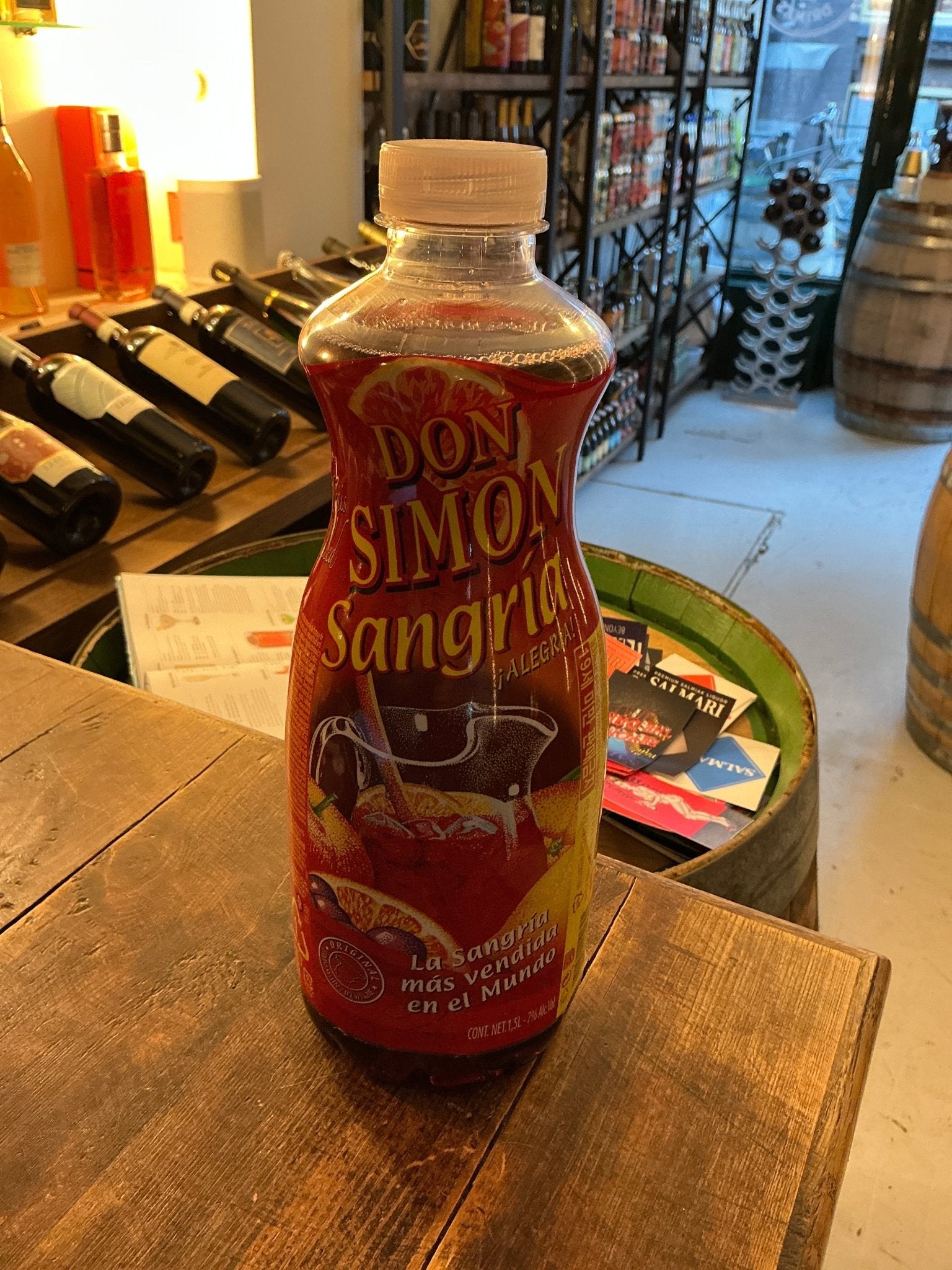 Don Simon Sangria in a clear plastic bottle with red label featuring fruit illustrations, artisan pre-mixed liqueur, premium .