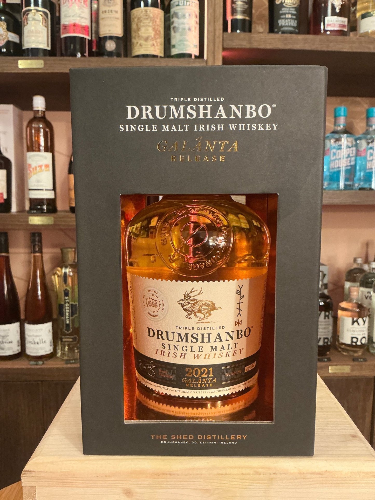 Drumshanbo Single Potstill Whiskey Galánta Release 2021 in premium bottle with botanical and spiced notes displayed in black .