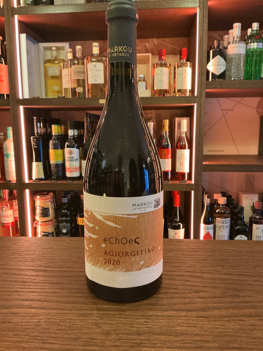 Echoes 2020 Greek red wine bottle with cream and gold label, premium artisanal spirit on wooden bar, specialty spirits.