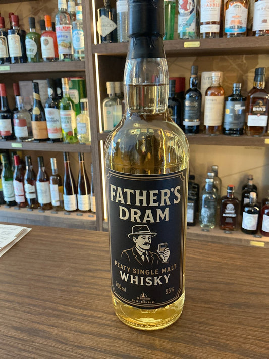 Father’s Dram Peaty Single Malt Whisky bottle with black label, aged premium distilled artisan spirit on wooden bar counter.